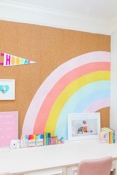 a room with a corkboard wall and pink chairs in front of the desk area