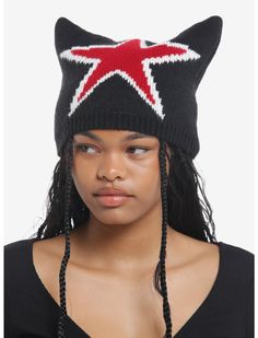 a woman wearing a black knit hat with a red star on the side and braids