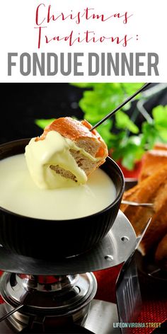 a bowl filled with pudding and cream on top of a metal stand next to some bread sticks