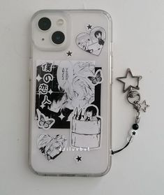 an iphone case with some stickers on it and a keychain attached to it