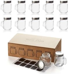 a set of six glass mason jars with lids and matching coasters in a box