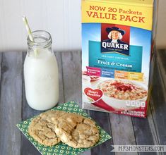 oatmeal cookies next to a carton of milk on a wooden table