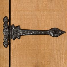 an iron handle on a wooden door