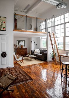 a loft apartment with wood floors and high ceilings