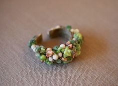 a close up of a ring made out of broccoli and other things on the ground