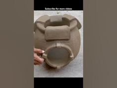 someone is making a vase out of clay