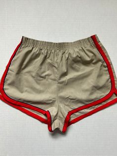 Here's a pair of Kmart gym shorts from the 1960! These feature an elastic waist band and red piping around the hems. Made in USA! Look Kool when wearing these shorts and stand out from the rest of the crowd. Condition: Excellent. No odors. One minor mark. Appear unworn. Examine all pictures for details. Style: 60s Brand: Kmart Color: Beige/Red Size: Large (36-38) Refer to measurements:  Waist unstretched: 12" Inseam: 2" Outter seam: 11" Please don't hesitate to ask any questions. Thanks for look Retro Cotton Athletic Shorts, 60s Sportswear, Gym Shorts, Vintage 1960s, Athletic Shorts, Waist Band, Dream Wardrobe, Short Outfits, Mens Shorts