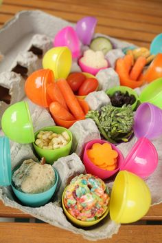 there are many different bowls and spoons on the table