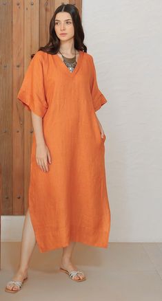 An absolute essential Kaftan dress made in comfortable and graceful Silk Linen fabric. The pipin detail on neck and sleeves just add to the magic. Dress has side slits and pockets for extra legroom and comfort. Makes for a perfect Holiday/Resort wear. Comes with a separate Cotton Lining to make for a comfort wear. Kaftan With Sleeves, Long Maxi Dress With Pockets For Beach, Beach-ready Long Maxi Dress With Pockets, Long Beach Maxi Dress With Pockets, V-neck Shift Dress With Pockets, Solid Color Shift Midi Dress With Pockets, Shift Midi Dress With Pockets, Elegant V-neck Linen Dress With Pockets, Solid Color Midi Dress With Pockets For Beach