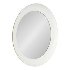 a white round mirror sitting on top of a wall