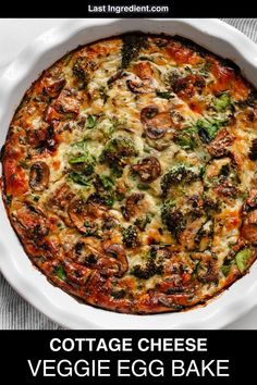 an egg bake in a white casserole dish with broccoli and mushrooms