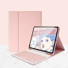 an open laptop computer sitting on top of a white table next to a pink ipad