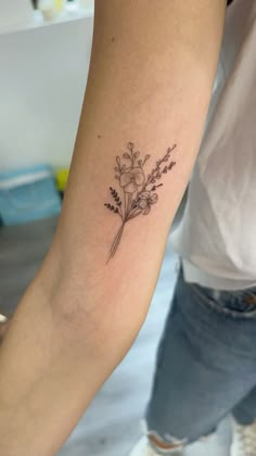 a person with a flower tattoo on their arm