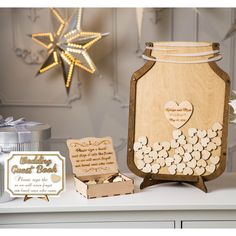 a wooden jar filled with lots of hearts next to a card and some other items