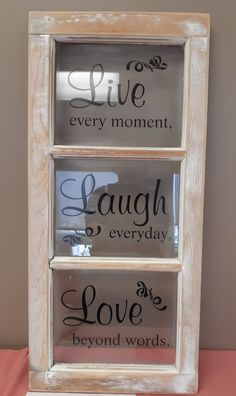 three glass shelves with sayings on them