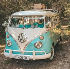 an old vw bus is parked in the woods