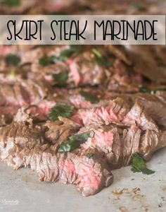 steak steak marinade on a cutting board with parsley sprigs and herbs