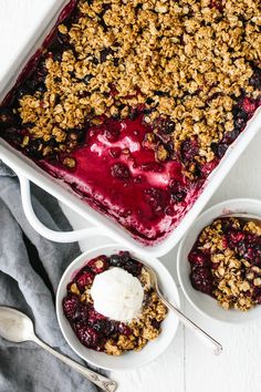 blueberry cobbler with ice cream in two bowls and spoons on the side