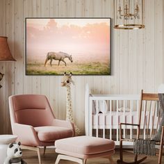 a giraffe standing next to a baby's crib in a room