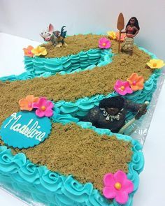 a birthday cake decorated with blue frosting and flowers on top of a white table