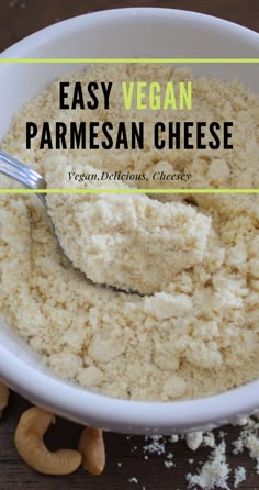 a white bowl filled with parmesan cheese next to cashews on a wooden table