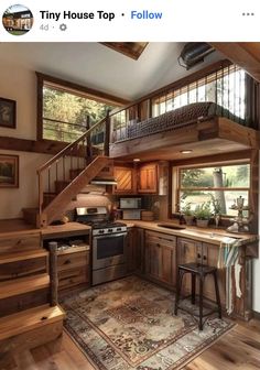 an open kitchen with stairs leading up to the second floor