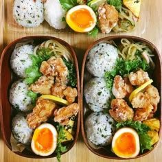 two trays filled with different types of food on top of a wooden table next to each other