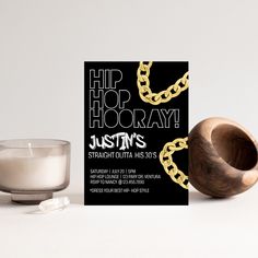 a candle next to a card that says hip hop hooray justin's