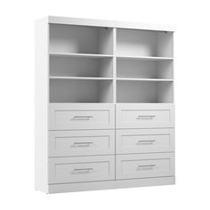 an empty white bookcase with drawers on it