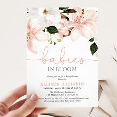 a person holding up a card that says babies in bloom with flowers and leaves on it