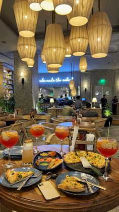 a table topped with plates of food and drinks