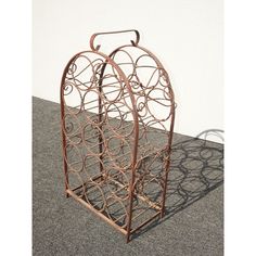 a metal wine rack sitting on top of a carpeted floor