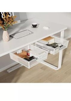 a white desk with drawers underneath it and a computer on the table next to it