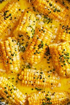 corn on the cob with butter and parsley in a skillet