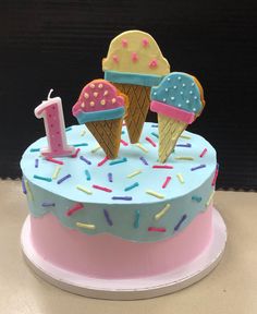 a birthday cake decorated with ice cream and sprinkles