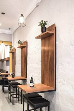 an empty restaurant with wooden tables and stools