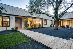 a house that has a wooden walkway leading to it