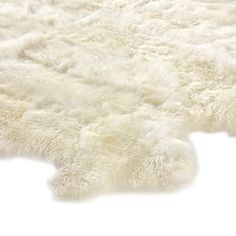 an area rug with white fur on it