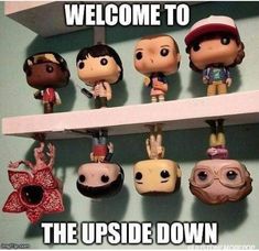 the upside down shelf is filled with little figurines that are hanging from it's sides