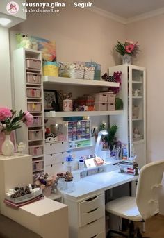 a white desk topped with lots of drawers next to a shelf filled with boxes and vases