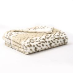 two white and brown animal print blankets on top of each other