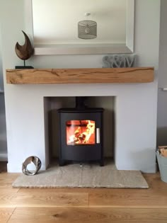 a wood burning stove sitting inside of a living room next to a firewood log