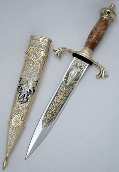 two different types of knifes on a white surface with gold trimming and ornate designs