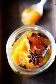 a glass jar filled with food on top of a wooden table