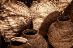 several woven vases sitting next to each other