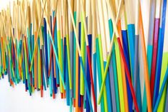 colorful sticks are lined up on the wall