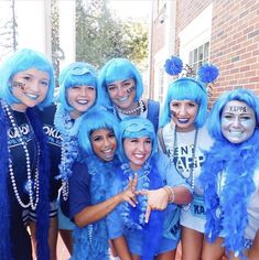 a group of women in blue wigs posing for the camera