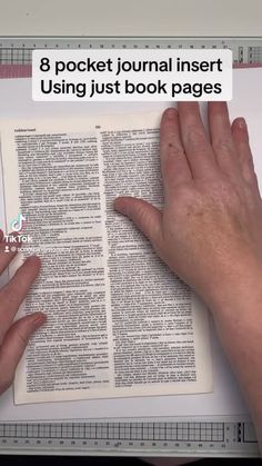 two hands are holding an open book with the text 8 pocket journal inserting using just book pages