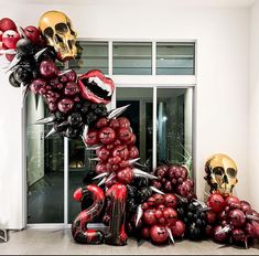 a bunch of balloons that are in the shape of skulls