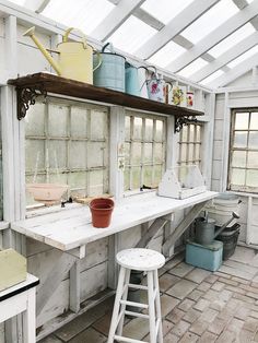 an old fashioned kitchen with pots and pans on the shelves